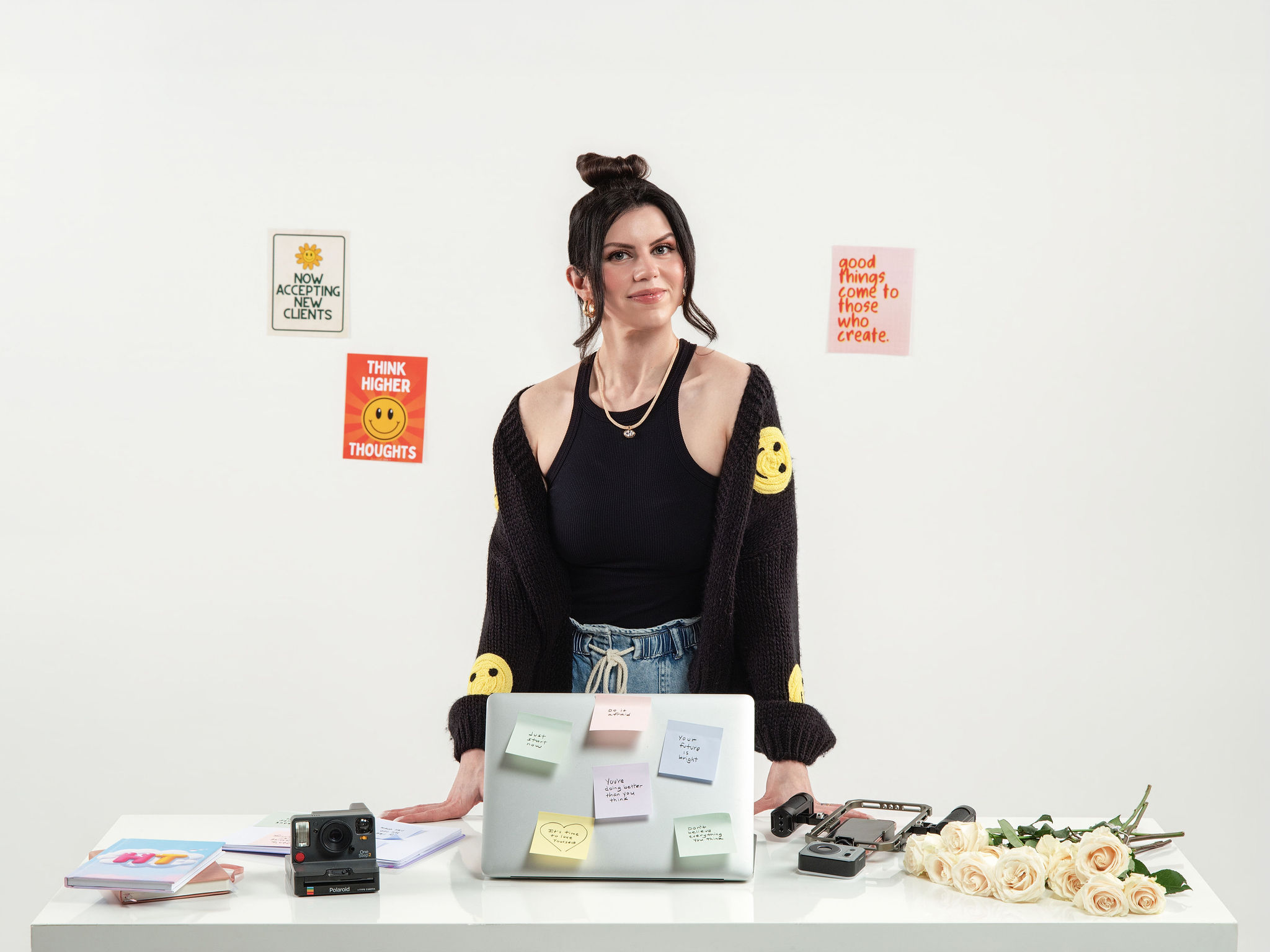 Meggan standing at a desk covered in sticky notes and planning materials