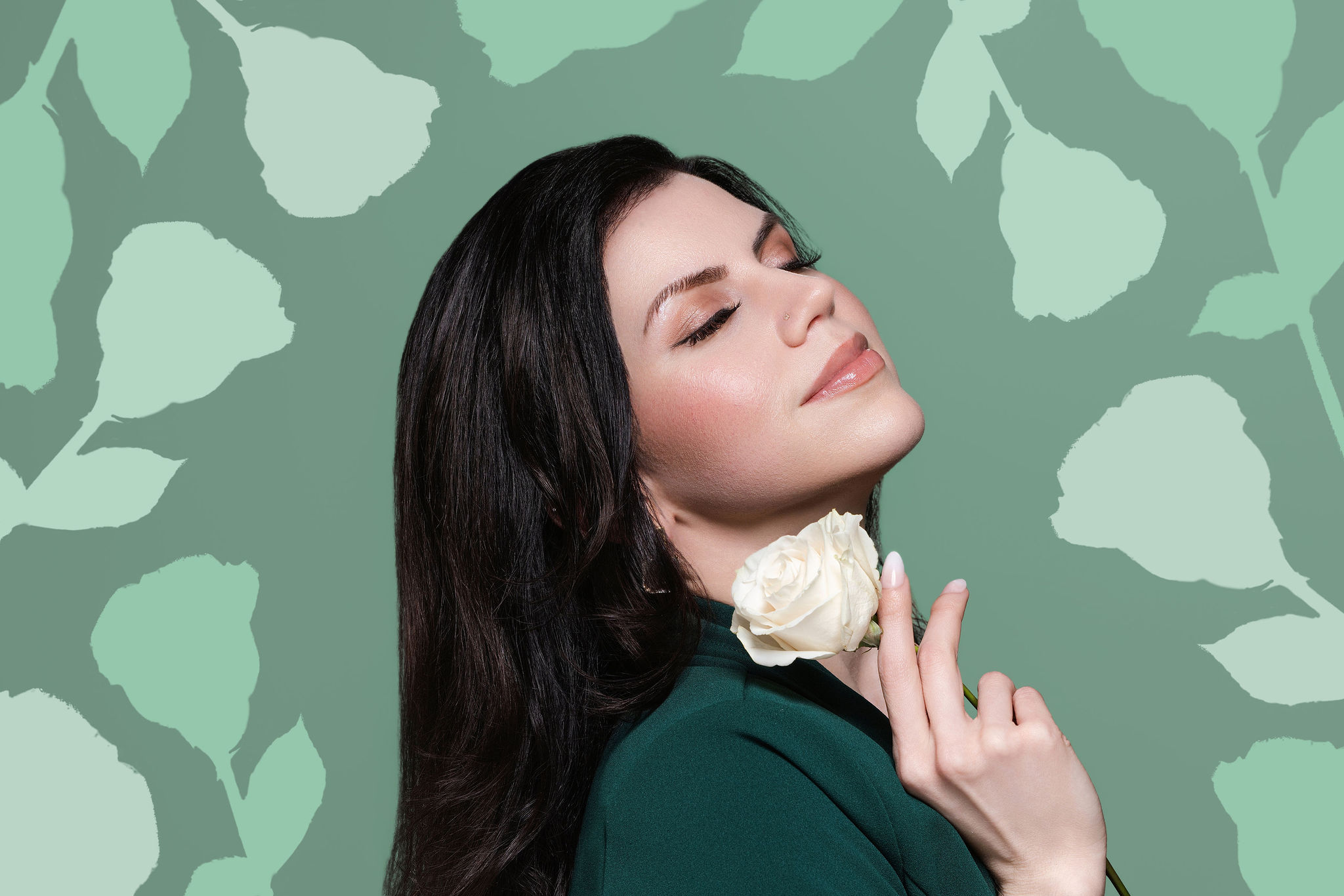 Meggan in profile holding a white rose against a green leaf-patterned backdrop
